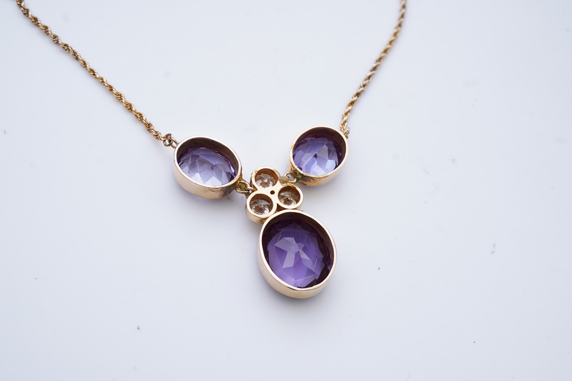 A synthetic colour-change sapphire and diamond pendant necklace